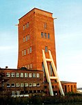 Individual features within the aggregate mining facility Martin-Hoop-Schacht IV (formerly Morgensternschacht IV): Mine administration building, gatekeeper's house with travel mark room, dining house with kitchen building, Steigerstube and Steigerbad, winding tower with carriage circulation as well as washrooms with equipment