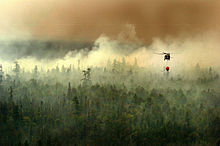 A helicopter of the Michigan National Guard conducting aerial firefighting near Tahquamenon Falls State Park Michigan National Guard firefighting.jpg