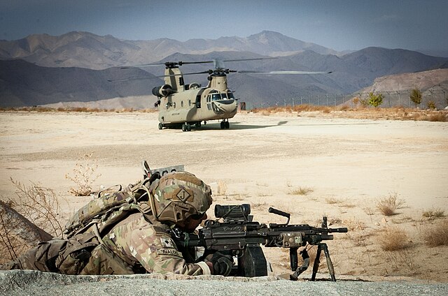 An automatic rifleman assigned to 1-505 PIR secures a landing zone for a CH-47 Chinook helicopter in Afghanistan.