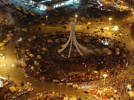 Police firing tear gas on Pearl Roundabout while protesters are fleeing.jpg