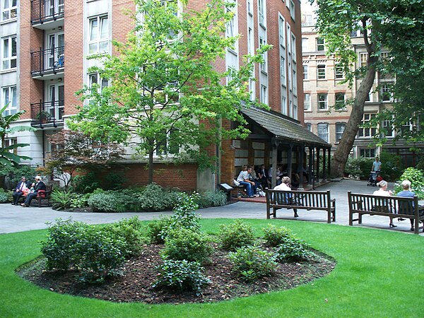 Postman's Park. The Memorial to Heroic Self-Sacrifice is beneath the awning in the central background.