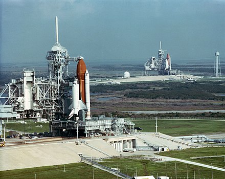 A view of two Space Shuttles on adjacent KSC Launch Complex 39 pads. Discovery (STS-41) is on LC-39B in the background, Columbia (STS-35) is on LC-39A in the foreground.