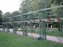 Structure holding cages used for listening to siskins at the singing contest of Sagra dei Osei, Italy Sagra dei Osei Carduelis spinus.JPG