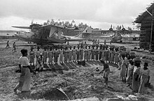 Singhalese women labourers RAF flying boat station at Red Hills Lake, Ceylon. Singhalese women labourers assist in the repair of the hardstanding areas of the RAF flying boat station at Red Hills Lake, Ceylon, September 1944. Parked behind them are Consolidated Catalina Mk IVs of No. 240 Squadron. CI1006.jpg