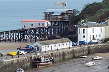 Tenby harbour in November 2004 at low-tide with the 1905 lifeboat station and the 2005 lifeboat station still under construction Tenby Harbour and Lifeboat Station - geograph.org.uk - 368719 (cropped).jpg