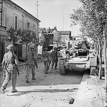 Infantrymen of the 1/7th Battalion, Queen's Royal Regiment (West Surrey) and a Stuart tank in Grazzanise, Italy, 12 October 1943. The British Army in Italy 1943 NA7706.jpg