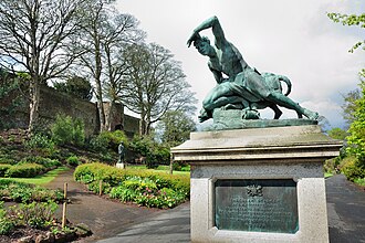 Part of the gardens showing statue by Edward Bowring Stephens (1815-1882) The Deer Stalker, with a section of the castle wall in the background The Deer Stalker in Northernhay Gardens.jpg