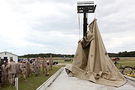 U.S. Marines with 2nd Marine Logistics Group, 8th Engineer Support Battalion, Bulk Fuel Company, stand-by while a 20,000 gallon collapsible tank is lifted to drain all remaining fuel inside on Bogue Field, North 120423-M-KS710-025.jpg