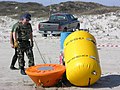 US Navy 050126-D-2006A-002 The French Navy Officer, LT Arnaud Lesquer assigned to Clearance Diving Team (CDT) Atlantic, observes a practice mine being attached to a transition buoy on Padre Island, Texas.jpg