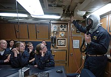 An EAB usage demonstration on board the USS Helena (SSN-725) US Navy 070727-N-4163T-139 Midshipmen are instructed on the proper way to don an Emergency Air Breather (EAB) aboard the Los Angeles-class attack submarine USS Helena (SSN 725).jpg