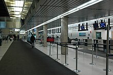 Interior of the old terminal prior to its closure YWGoldterminalcheckinarea.JPG