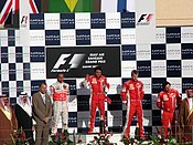 The podium ceremony (from left to right: Lewis Hamilton, Felipe Massa, Kimi Raikkonen and Luca Baldisserri.) 2007 Bahrain GP podium.jpg