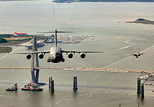 An F-15 Eagle from the 60th Fighter Squadron, Eglin Air Force Base, Fla., escorts a C-17 Globemaster III from the 14th Airlift Squadron, Joint Base Charleston, S.C., as they fly over the USS Yorktown and the Arthur J. Ravenel Jr. Bridge in the Charleston, S.C., area during a local training mission 315th-c-17-charleston.jpg