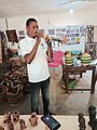 A man using a traditional made smoke pipe in upper east region of Ghana