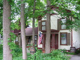 The semi-wooded lawn of the Wildflower House is home to 32 trees and 36 types of plants. Belvidere Il Lampert Wildflower House2.jpg