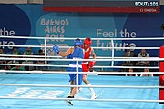 Deutsch: Boxen bei den Olympischen Jugendspielen 2018 Tag 12, 18. Oktober 2018 - Kampf um Bronze im Leichten Weltergewicht Jungen – Hassan Azim (Großbritannien, rot) schlägt Mohammed Boulaouja (Marokko, blau) RSC; Ringrichter ist Wulfren Olivares Peréz (Kolumbien). English: Boxing at the 2018 Summer Youth Olympics on 18 October 2018 – Bronze Medail Match Light Welterweight Boys - Hassan Azim (Great Britain, red) beats Mohammed Boulaouja (Morocco, blue) RSC; Referee is Wulfren Olivares Peréz (Columbia). Español: Boxeo en los Juegos Olímpicos Juveniles de Verano de 2018 en 18 de octubre de 2018 - Medalla de bronce de los hombres ligeros de peso welter: Hassan Azim (Gran Bretaña, rojo) vence a Mohammed Boulaouja (Marruecos, azul) RSC; El árbitro es Wulfren Olivares Peréz (Colombia).