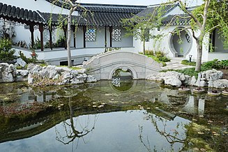 Bridge reflecting in lake inside Dunedin Chinese Garden.jpg