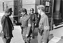 Erno Gombos, (r.) aide-de-camp to Ferenc Szalasi and Gyula Gombos's son, along with a Honved officer and a member of the Arrow Cross Party, in front of the Ministry of Defense, 1944. Bundesarchiv Bild 101I-680-8283A-27A, Budapest, ungarische Soldaten vor Verteidigungsministerium.jpg