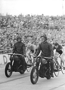 Lothar Meister (right) behind his pacer in 1958 Bundesarchiv Bild 183-57701-0002, Peter Groning, Lothar Meister.jpg