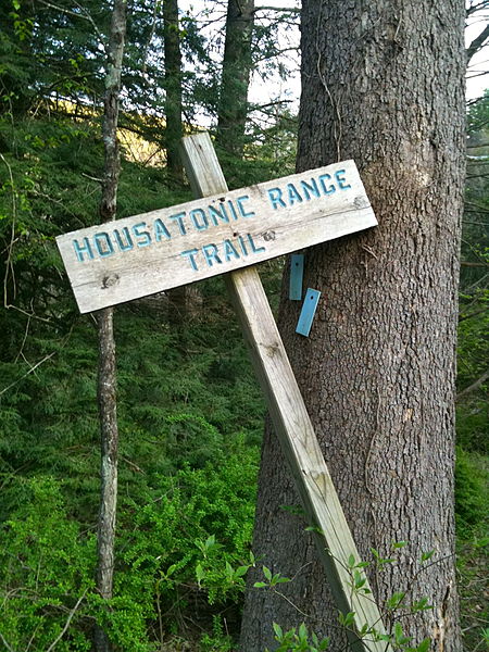 At the Housatonic Range Trail's Northern Terminus: a wooden trail head sign and light blue painted wood tags indicating a left turn.