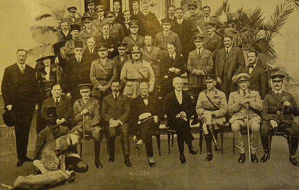 The delegates with lion cubs at left, and Lawrence of Arabia in the second row, fourth from right in a dark suit