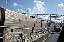 Exterior of passenger shuttle carriages, with cars queuing to board (2010) Channel Tunnel car shuttle 2010 3481.JPG