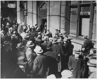 In the depths of the Great Depression, ca. 1933, anxious depositors line up outside of a New York bank. The new president, Franklin D. Roosevelt, had just temporarily closed the nation’s banks to end the drain on the banks’ reserves. Only those banks that were still solvent were permitted to reopen after a four-day “bank holiday.”