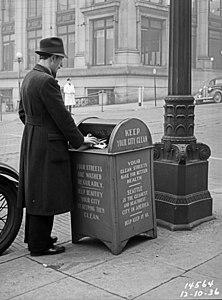 A man throwing the trash in Downtown Seattle, 1936.