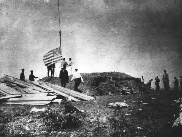 1st Marine Battalion raising the United States flag at the Battle of Guantánamo Bay on June 10, 1898.