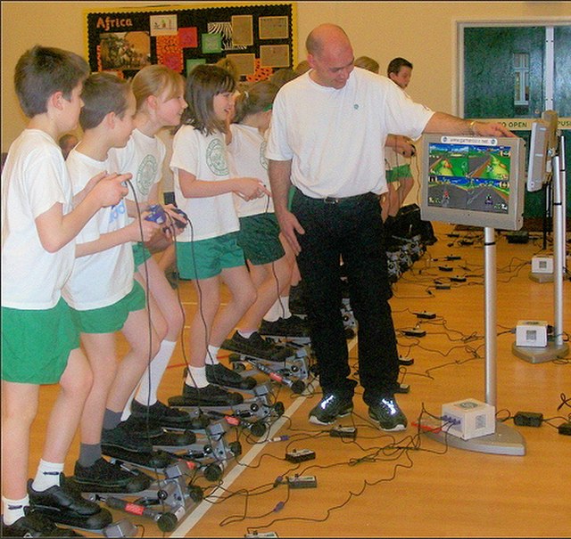 A group of schoolchildren exercise while playing the GameCube in Hilton, Derbyshire.