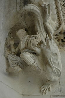 A demon gives an Orsini bomb to a worker. Sculpture from the Sagrada Familia, Barcelona. Gaudi sagrada terrorist.jpg