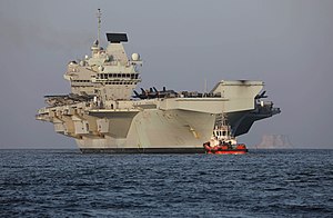 HMS Queen Elizabeth arriving at Duqm Port, Oman in November 2021. HMS Queen Elizabeth Duqm Port Oman.jpg