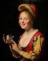 امرأة شابة تحمل مدلاة بريشة الرسام الهولندي جيرارد فان هونثورست 1625. متحف سانت لويس للفنون، ميزوري.