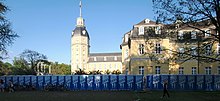 A long row of chemical toilets at Karlsruhe Palace, Germany KA Schloss Dixi.jpg