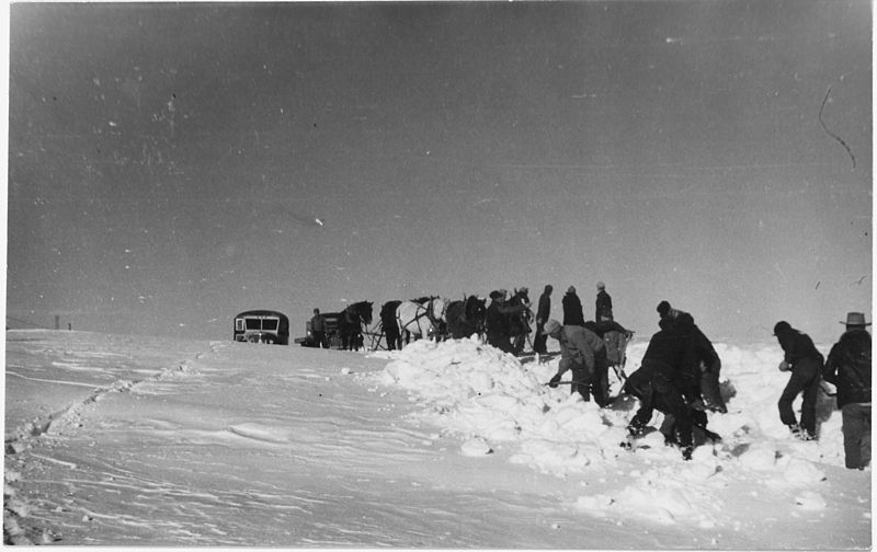 File:Men clear a path for the stuck school bus while horses rest in the background - NARA - 285534.jpg