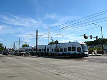 The Link Light Rail crosses an intersection near Othello Station in Seattle..