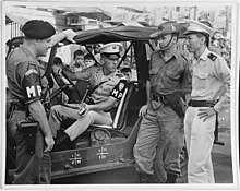 American, Australian, and New Zealand military police with a civilian police officer in Saigon during the Vietnam War, 1965 NH 73239 International Police patrol.jpg