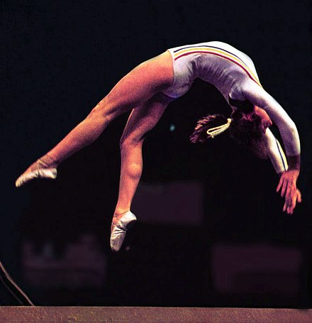 Nadia Comăneci in 1976. The artistry and grace of Comăneci and Soviet gymnast Olga Korbut gave the sport global popularity.[15]
