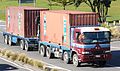 日本と同様に、日野製右ハンドル仕様ながらも、20 ft積載トラックが、20 ft積載台車を牽引している風景。