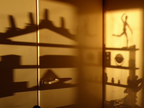 Shadow of a shelf with trinkets