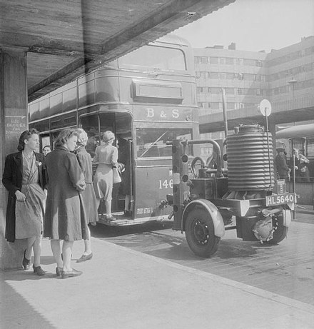 A bus, powered by wood gas generated by a gasifier on a trailer, Leeds, England c.1943