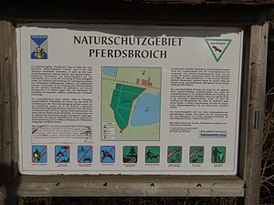 Information board on the edge of the horse brook