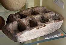 Pottery tray with 8 compartments. Redware, rectangular. 11th Dynasty. From Kurna (Qurnah), Egypt. The Petrie Museum of Egyptian Archaeology, London