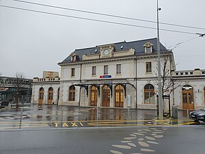 Three-story station building with a clock