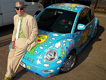 James Rizzi with the Volkswagen New Beetle designed by him.