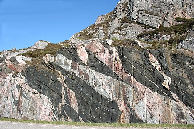Scourie dykes (now foliated amphibolites) cutting grey gneiss of the Scourie complex, both deformed during the Laxfordian tectonic event and cut by la