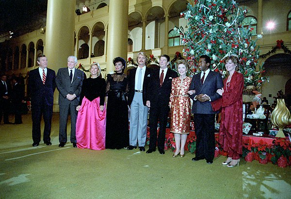 U.S. President Ronald Reagan and First Lady Nancy Reagan with a group at NBC's taping of its "Christmas in Washington" special in the Pension Building