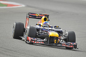 Sebastian Vettel driving a Formula One car on an asphalt track surface in Bahrain