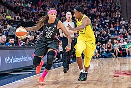 Seimone Augustus (33) brings the ball down the court as she's guarded by Jewell Loyd (24)