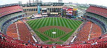 A panoramic view of Shea Stadium from the upper deck behind home plate before a baseball game in 2008. The construction of Citi Field is visible beyond the outfield wall.